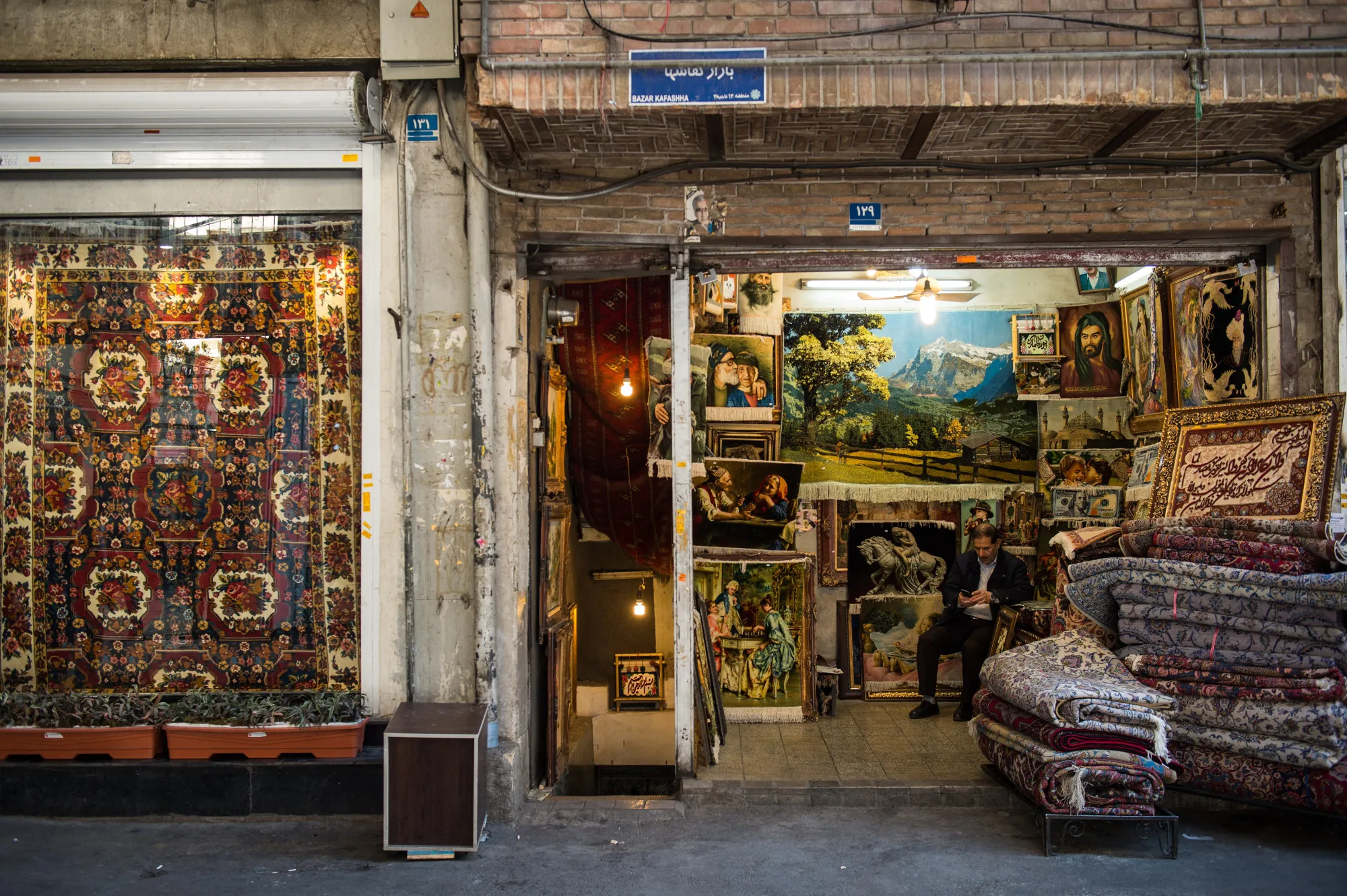 A salesman waits for customers in the rug bazaar in Tehran.