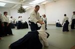 People who may or may not be bus drivers practice the Japanese martial art of aikido.