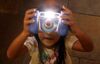 A child plays with the Kidizoom Multimedia Digital Camera made by V-Tech. Hackers accessed 5 million customer accounts through VTech’s Learning Lodge database, where users download applications, learning games and e-books.
