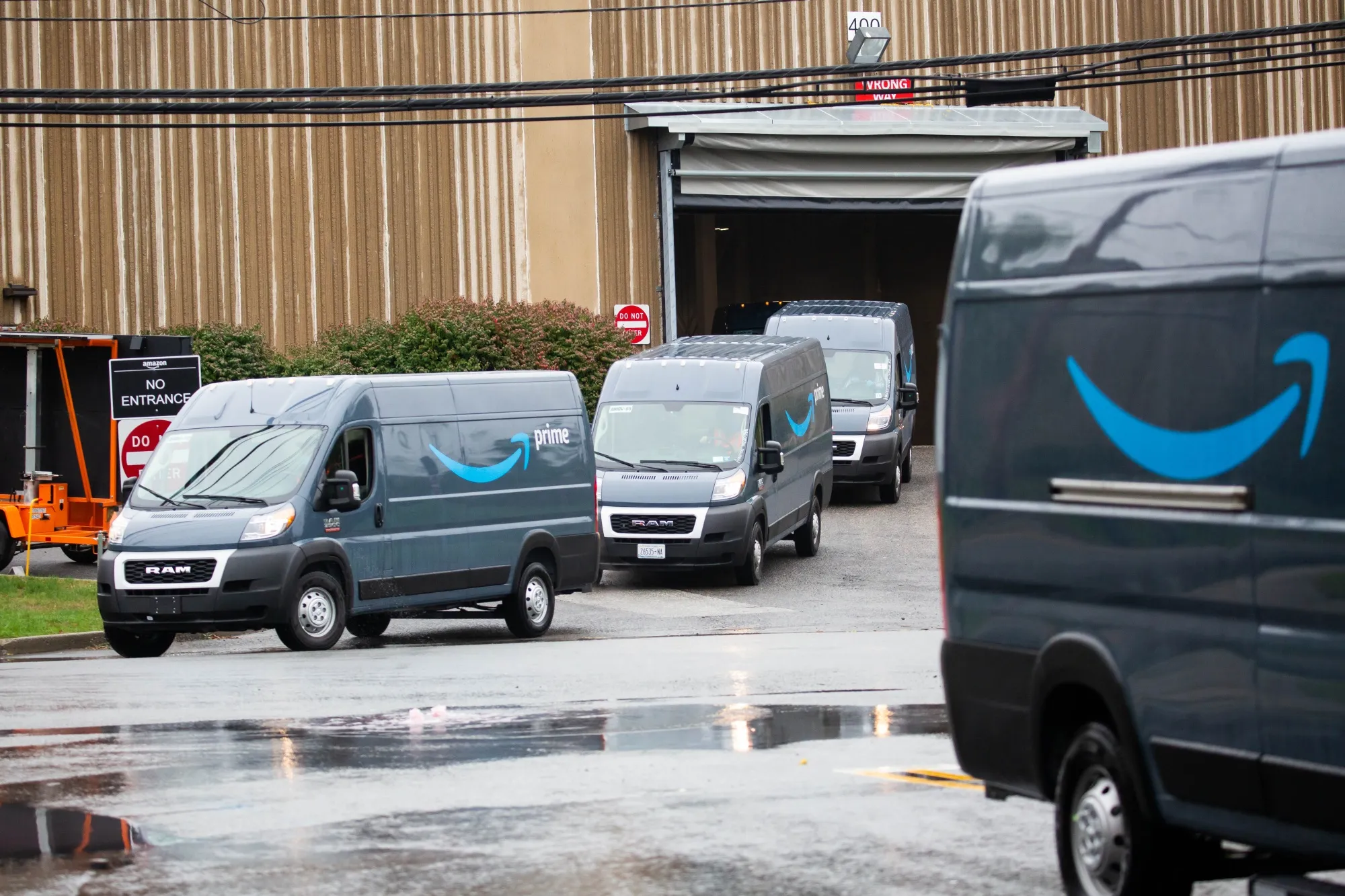 Trucks leave an Amazon delivery station in Carlstadt, New Jersey.