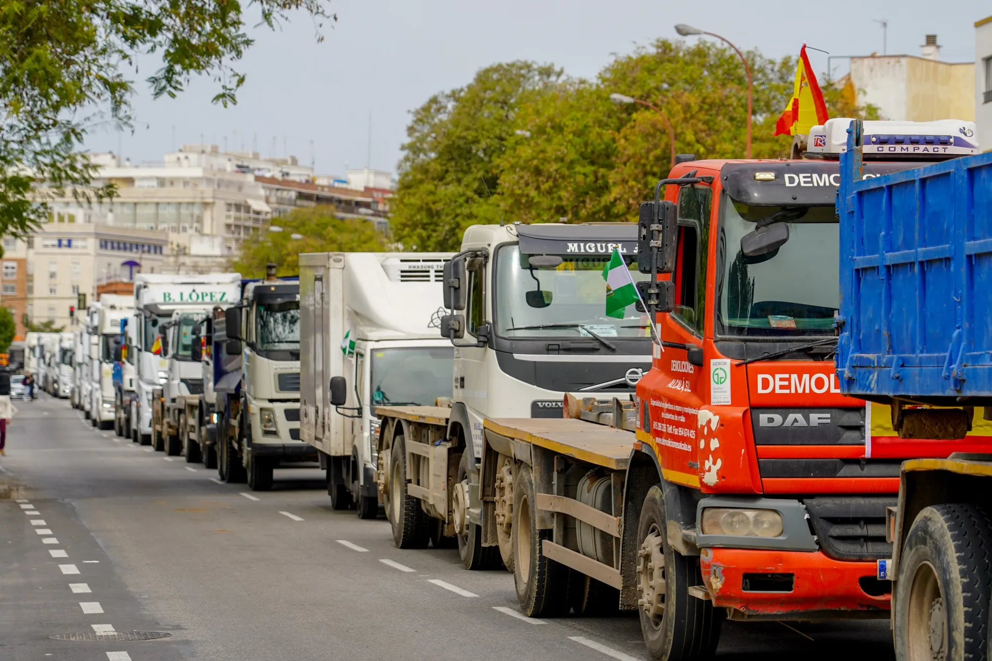 Trucks drive at low speeds on the fifth day of strikes, in Seville, Spain, on March 18.