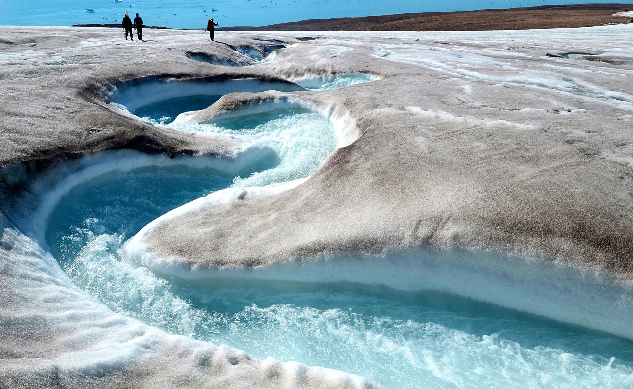 A stream flows made by a melting glacier near Qaanaaq, Greenland.
