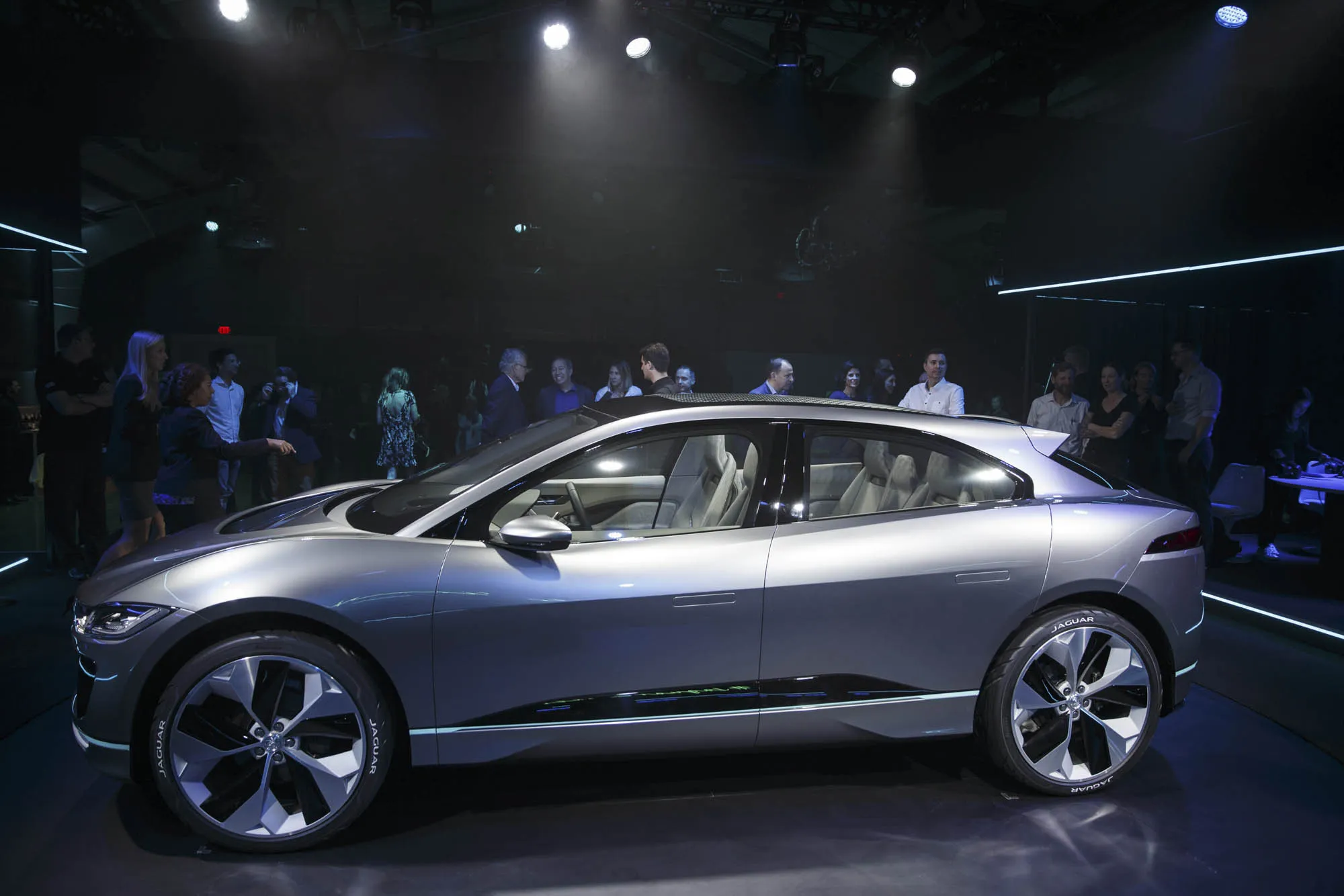 Attendees view the Jaguar Land Rover Automotive PLC I-Pace Electric Concept luxury sport utility vehicle (SUV) during an event in Los Angeles, California, U.S., on Sunday, Nov. 13, 2016. Jaguar's working on its first electric car, a sport utility vehicle with a large glass roof and cutouts in the hood, as the luxury brand joins the race to meet ever-tightening emissions rules.
