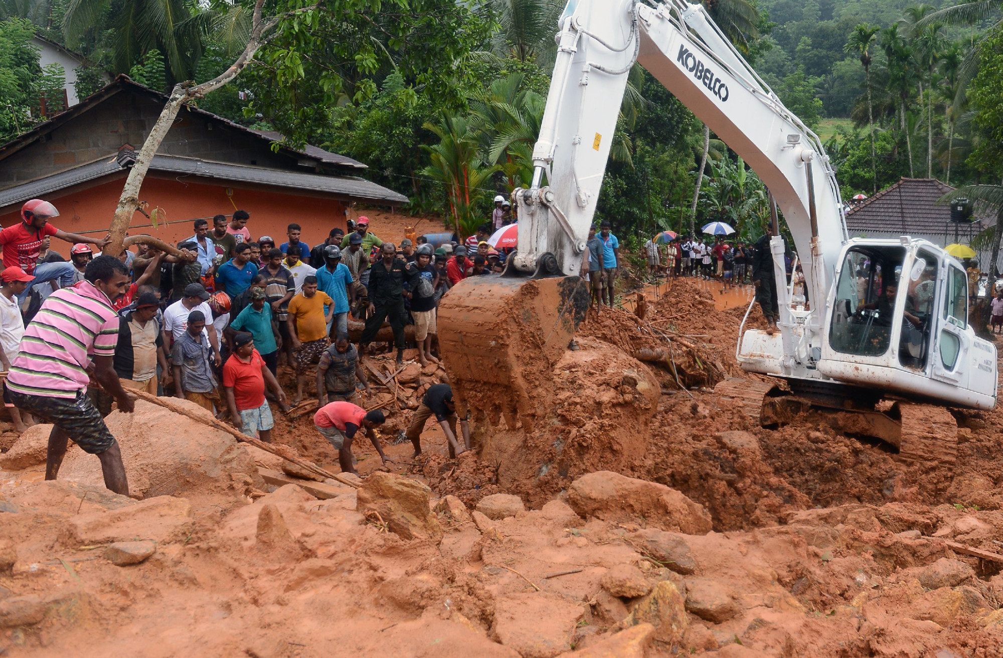 Rescue workers and villagers search for survivors at the site of a mudslide in Bellana village in Kalutara, Sri Lanka, on May 26.
