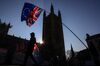 Anti-Brexit campaigners wave a European Union flag and a Union Jack, also known as a Union Flag, during a protest near the Houses of Parliament in London, U.K., on Wednesday, Feb. 27, 2019. Leading Brexit purist Jacob Rees-Mogg, who has opposed U.K. Prime Ministers Theresa May's exit deal, appears to be softening his stance, making it more likely that the divorce agreement could win Parliamentary approval next month.