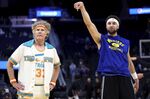 Actor Will Ferrell, left, watches as Golden State Warriors guard Klay Thompson warms up for the team's NBA basketball game against the Los Angeles Clippers in San Francisco, Tuesday, March 8, 2022. (AP Photo/Jed Jacobsohn)
