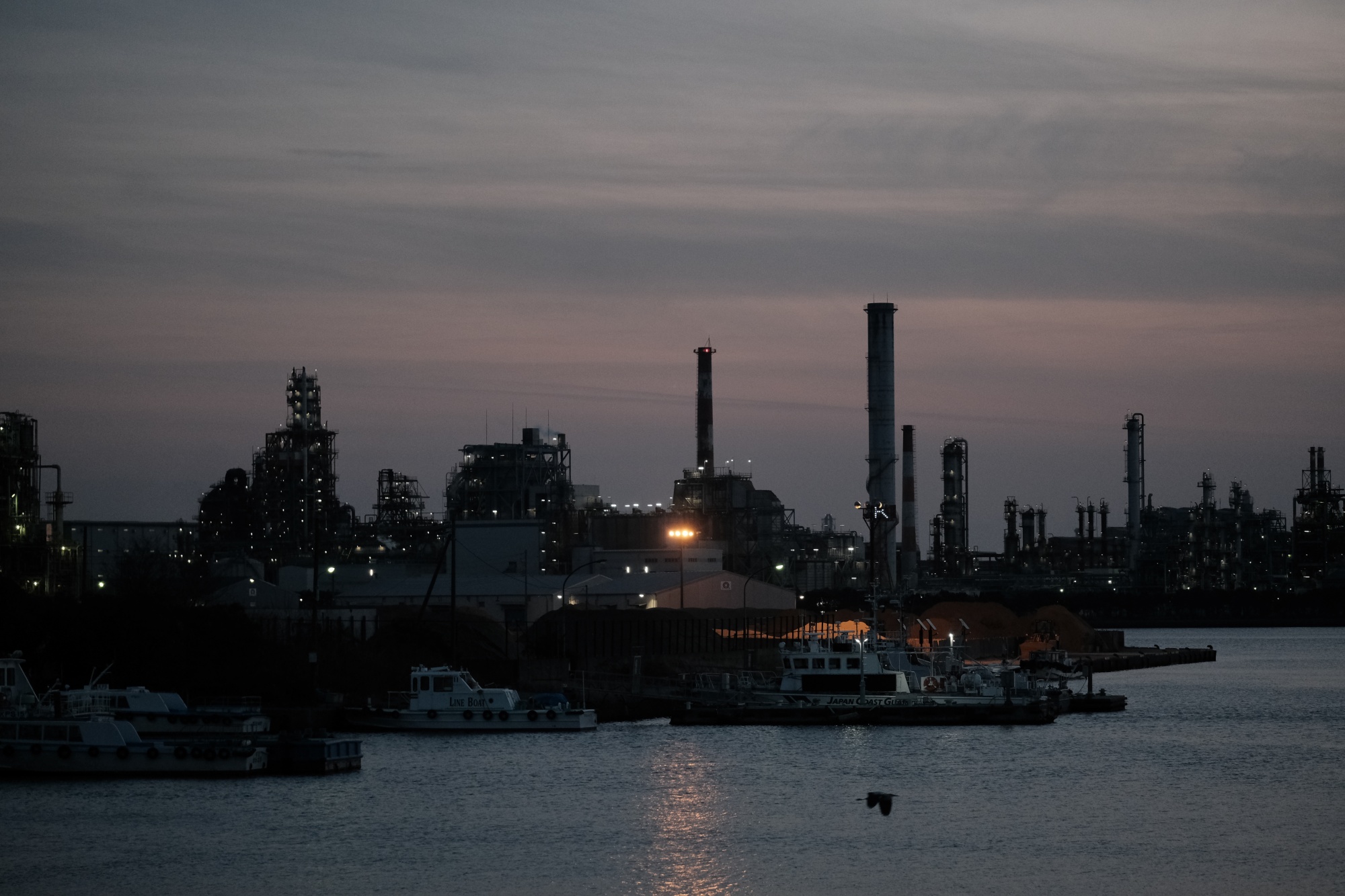 Plant stacks at night in the Keihin Industrial Area in Kawasaki, Kanagawa Prefecture, Japan, Thursday, February 11, 2021. Japan's economy is estimated to have ended the pandemic year of 2020 with growth topping Double digits, a show of resilience that suggests the country could emerge from a damaging state of emergency this quarter on a less unstable footing.