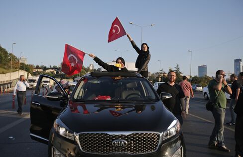 Turkish people wave the national flags in Istanbul, Turkey, Saturday, July 16, 2016.