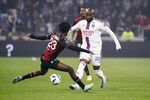 Moussa Dembele of Olympique Lyonnais passes the ball against Jordan Lotomba of OGC Nice during the Ligue 1 match in Lyon, France, on Nov.&nbsp;11.