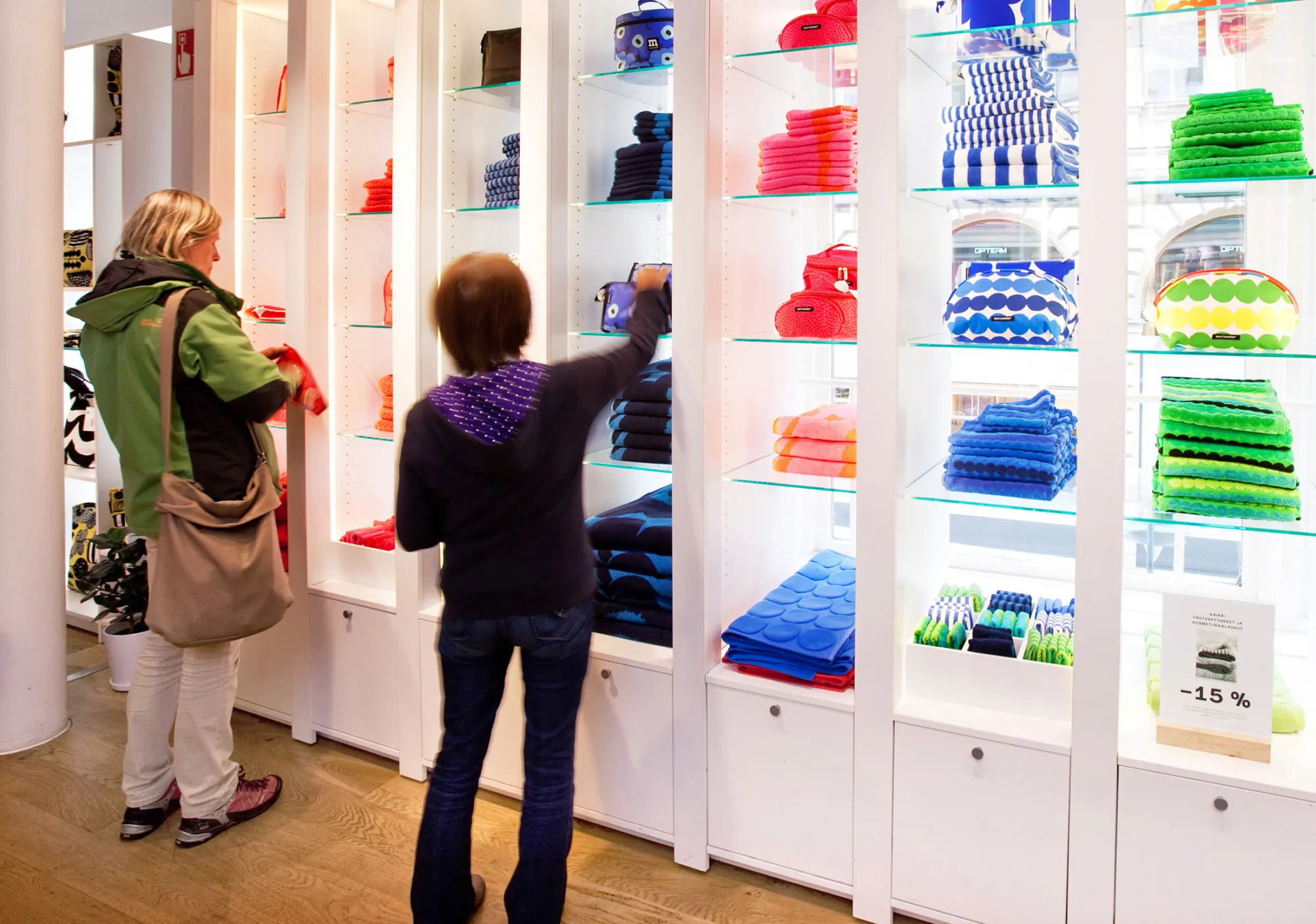 Customers inspect homeware products and fabrics at a store in Helsinki.
