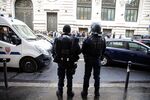 French riot police monitor employees re-entering the the Blackrock offices after they were evacuated due to a protest inside the building in Paris on Feb. 10.