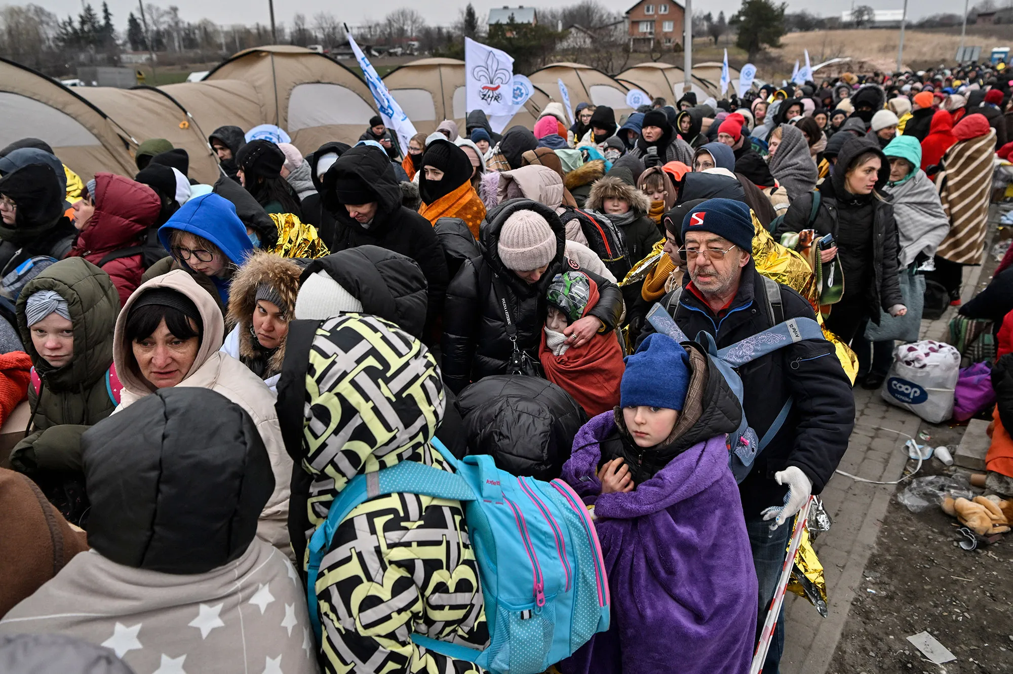 Migrants&nbsp;wait to be transferred to a train station after crossing the Ukrainian border into Poland,&nbsp;on March 7.&nbsp;
