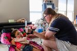 In August, Jennifer Alvarado, an&nbsp;Aveanna Healthcare client, feeds her seven-year-old daughter Sophia.