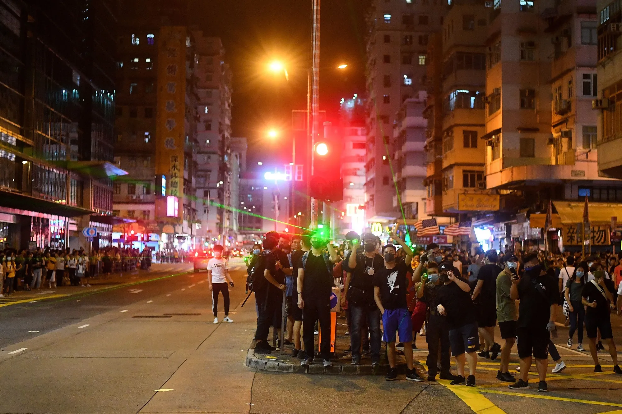 Protestors flash laser-lights at the police in Sham Shui Po on Aug. 14.