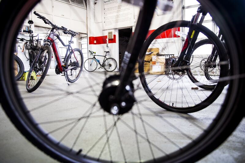 Electric bicycles displayed for sale and rent at a shop in Watertown, Massachusetts.