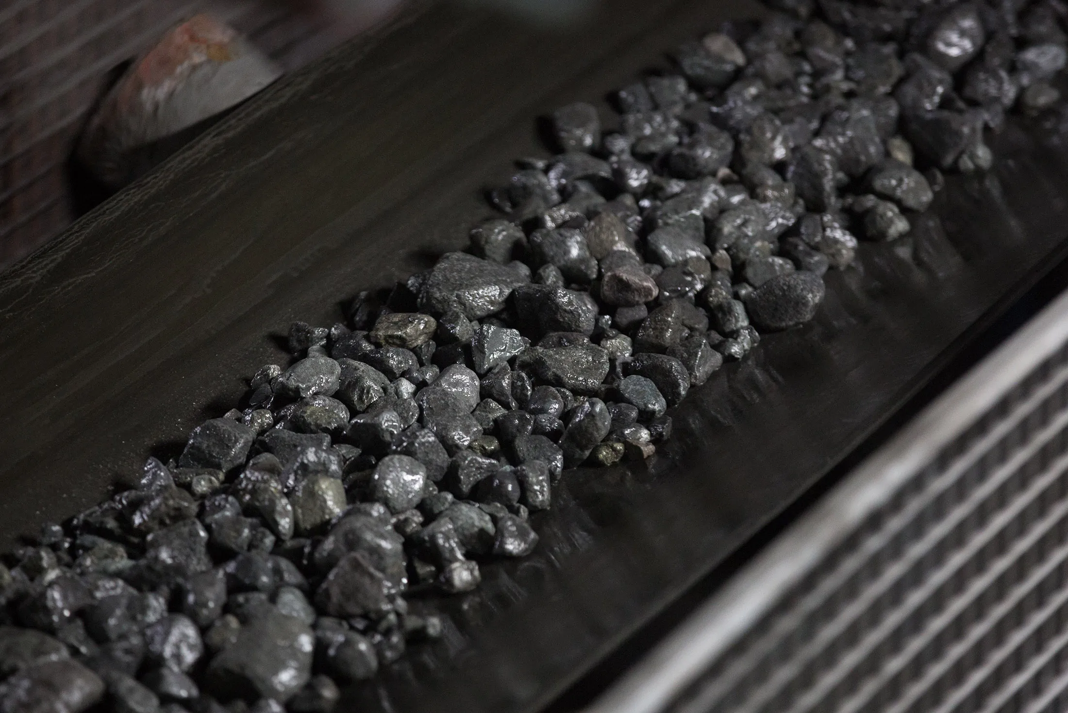 Copper-nickel ore moves along a conveyor belt at the Talnakh concentrator plant, operated by MMC Norilsk Nickel PJSC, in Norilsk, Russia, on Wednesday, Oct. 18, 2017. Norilsk Nickel, which mines the rich deposits of nickel, copper and palladium near Norilsk, has spent 2.5 billion rubles ($40 million) to lay fiber-optic cabling in the Siberian tundra.