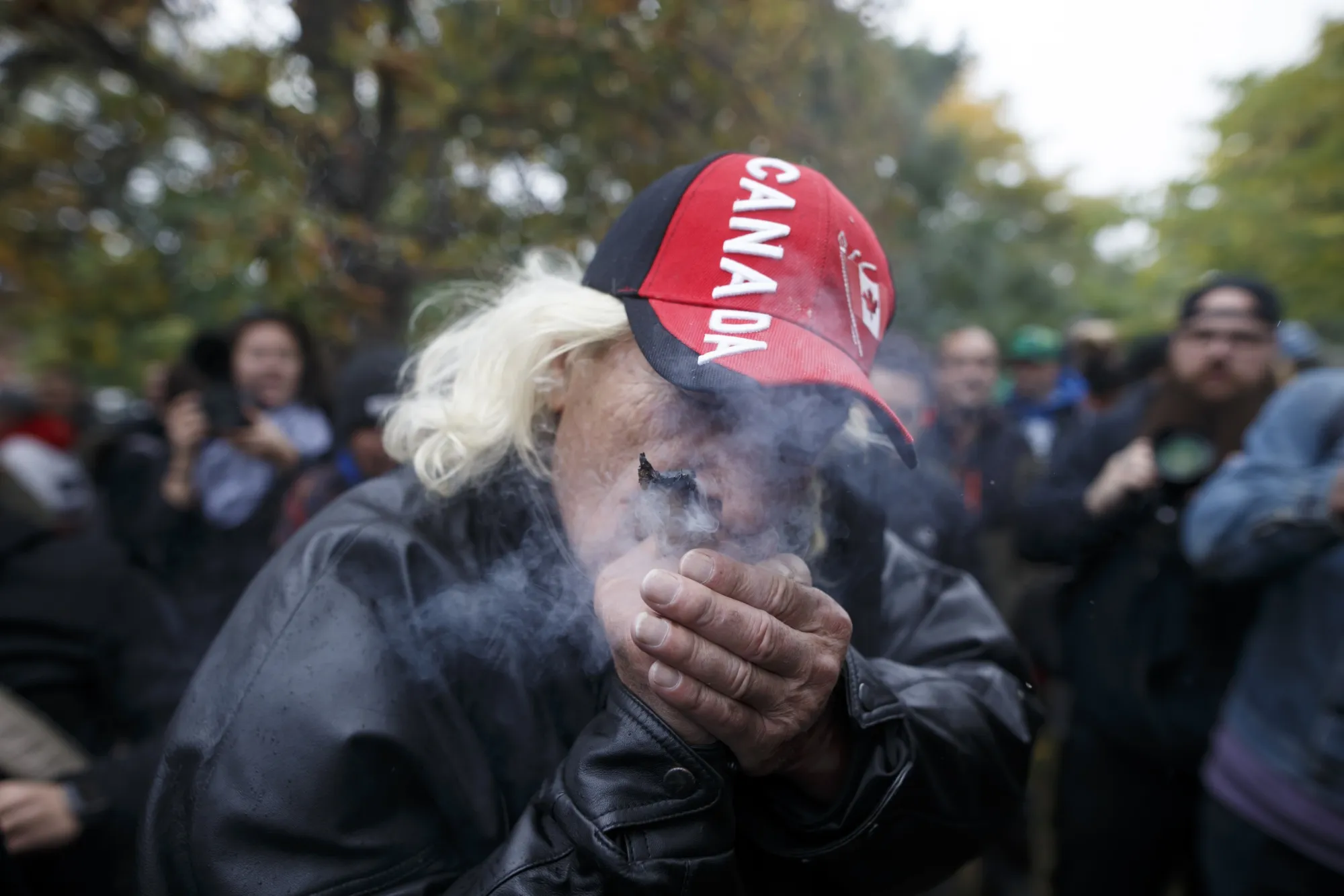 A man smokes a joint during a celebration of the legalization of marijuana in Toronto on Oct. 17, 2018.&nbsp;