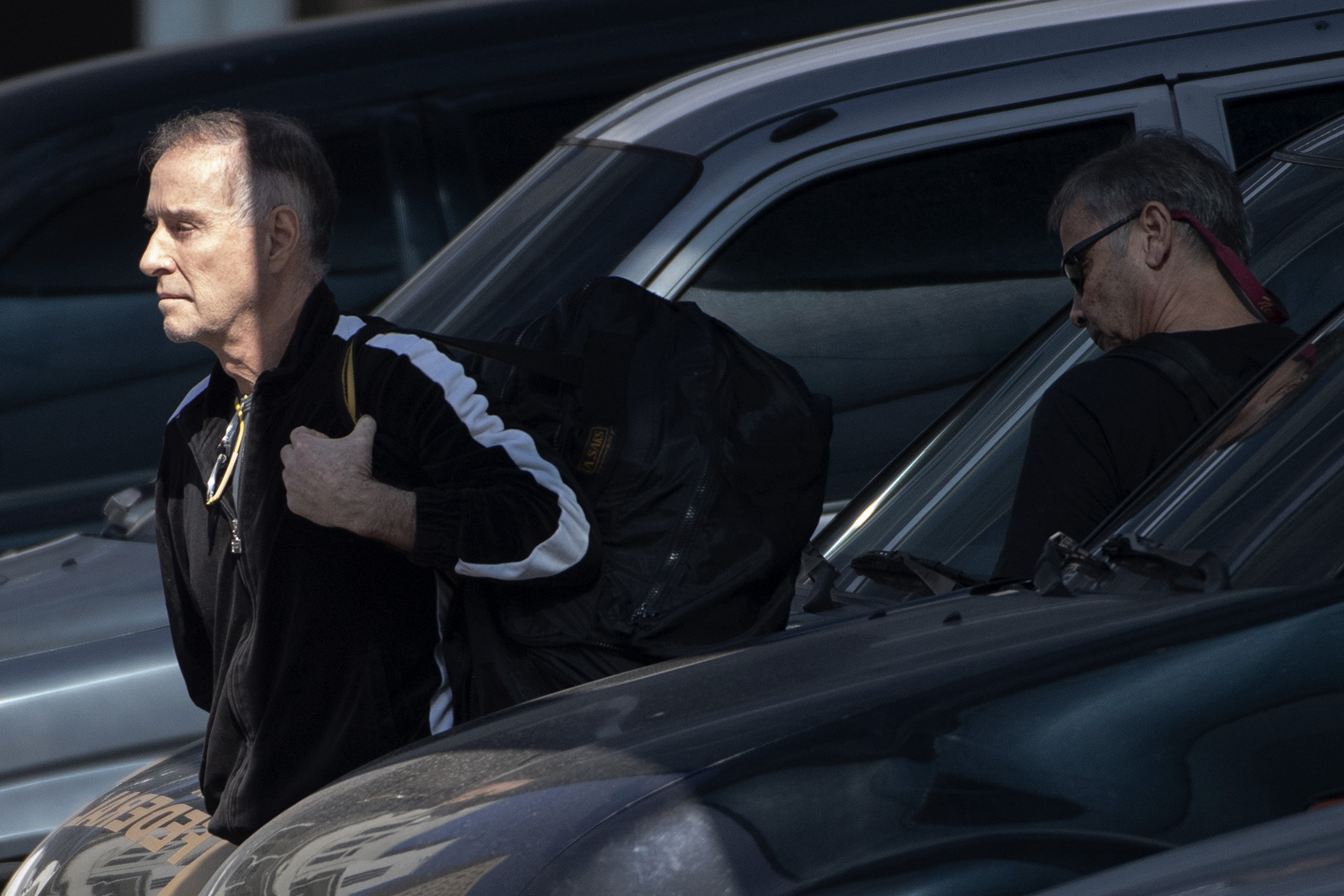 Eike Batista, left, arrives at the Federal Police headquarters on Aug. 8.