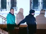 Alexey Navalny is escorted by a police officer in Khimki, Russia, on Jan. 17.