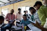 An invigilator, seated center, collects papers at an employment exam for a motorcycle manufacturer at the Government Industrial Training Institute in Lucknow, Uttar Pradesh, India, on Wednesday, Sept. 4, 2024. In most cities and villages in India, the economic “boom” isn’t creating enough quality jobs for the millions of people entering the workforce each year.