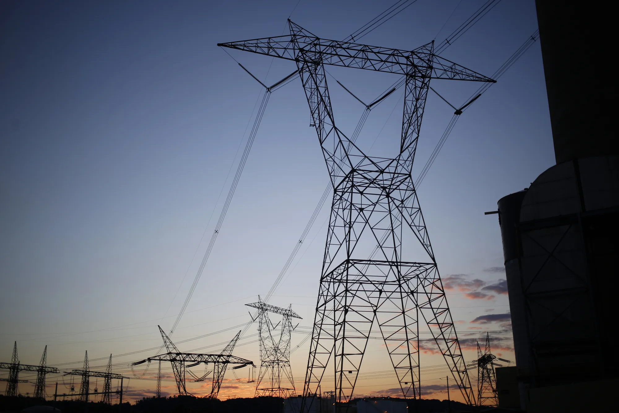 Transmission lines stand at the American Electric Power Co. (AEP) coal-fired John E. Amos Power Plant at dusk in Winfield, West Virginia, U.S., on Wednesday, July 18, 2018.
