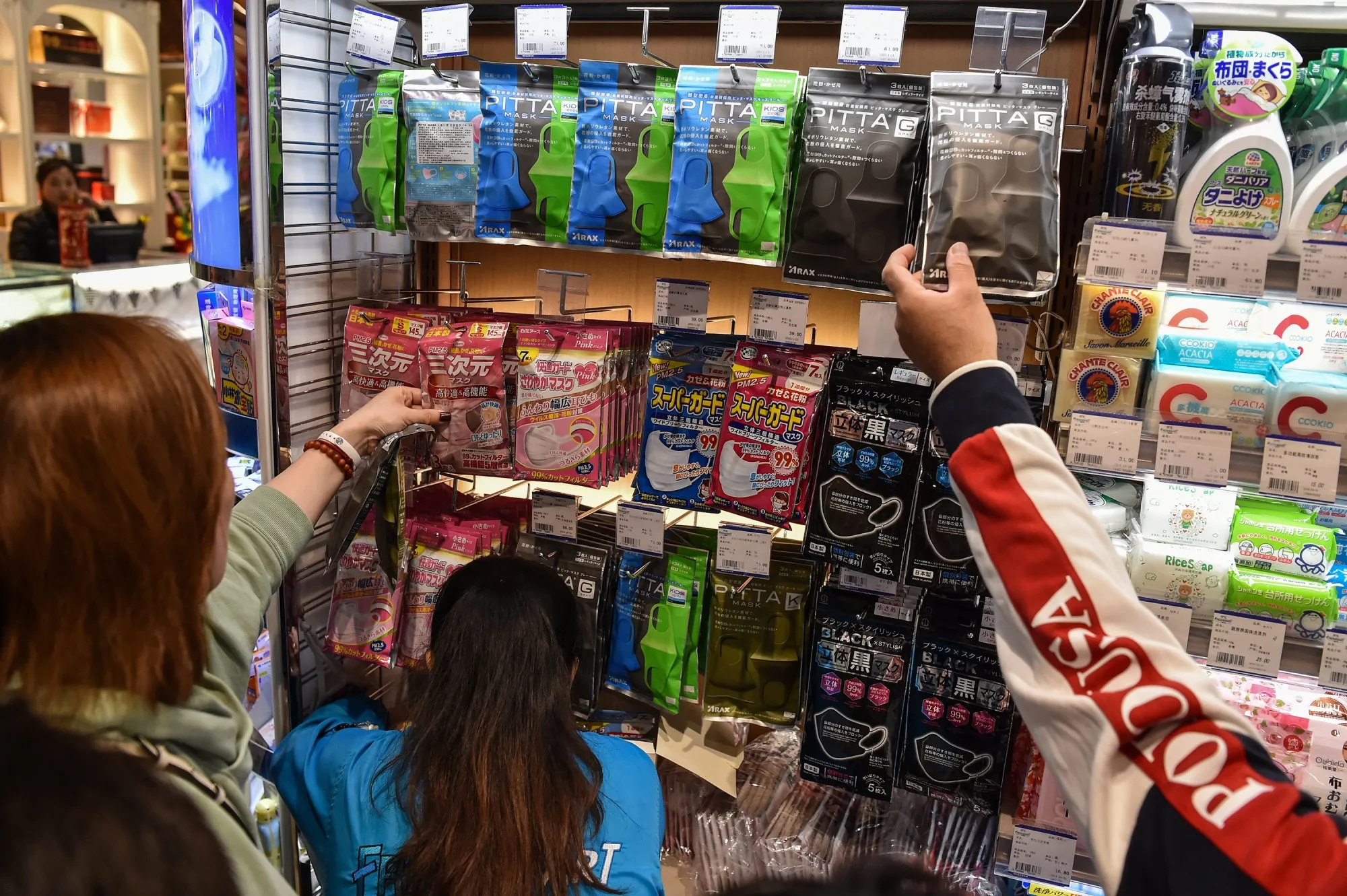 People buy protective masks in a market in Shanghai on Jan. 22.