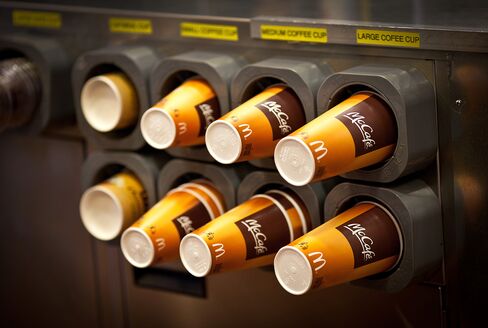 Coffee Cups sit in Dispensers at a McDonald's Corp. Restaurant
