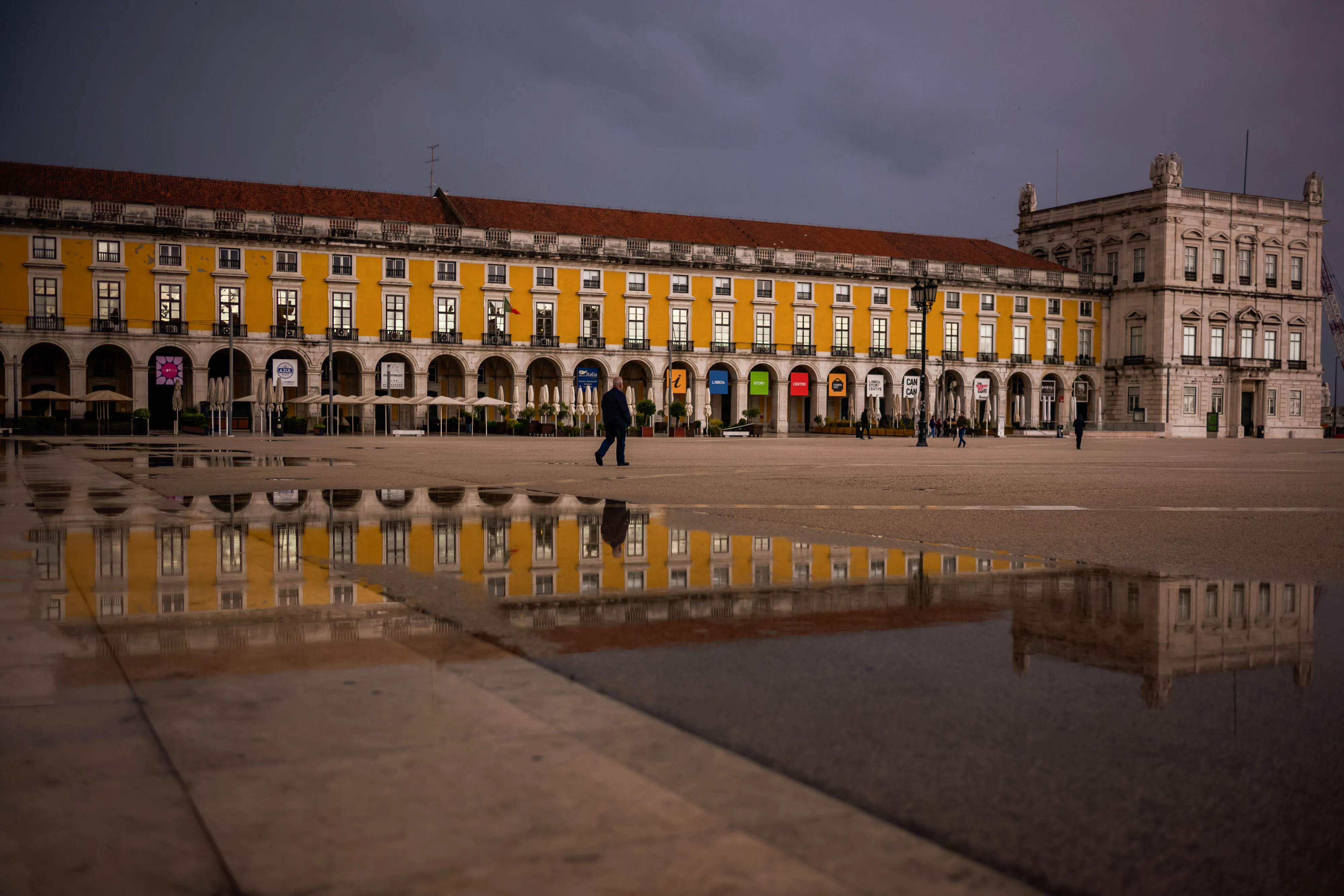 A pedestrian walks through a deserted Praca do Comercio in Lisbon, Portugal on&nbsp;May 14.