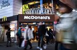 Pedestrians walk past a McDonald's restaurant in Tokyo.