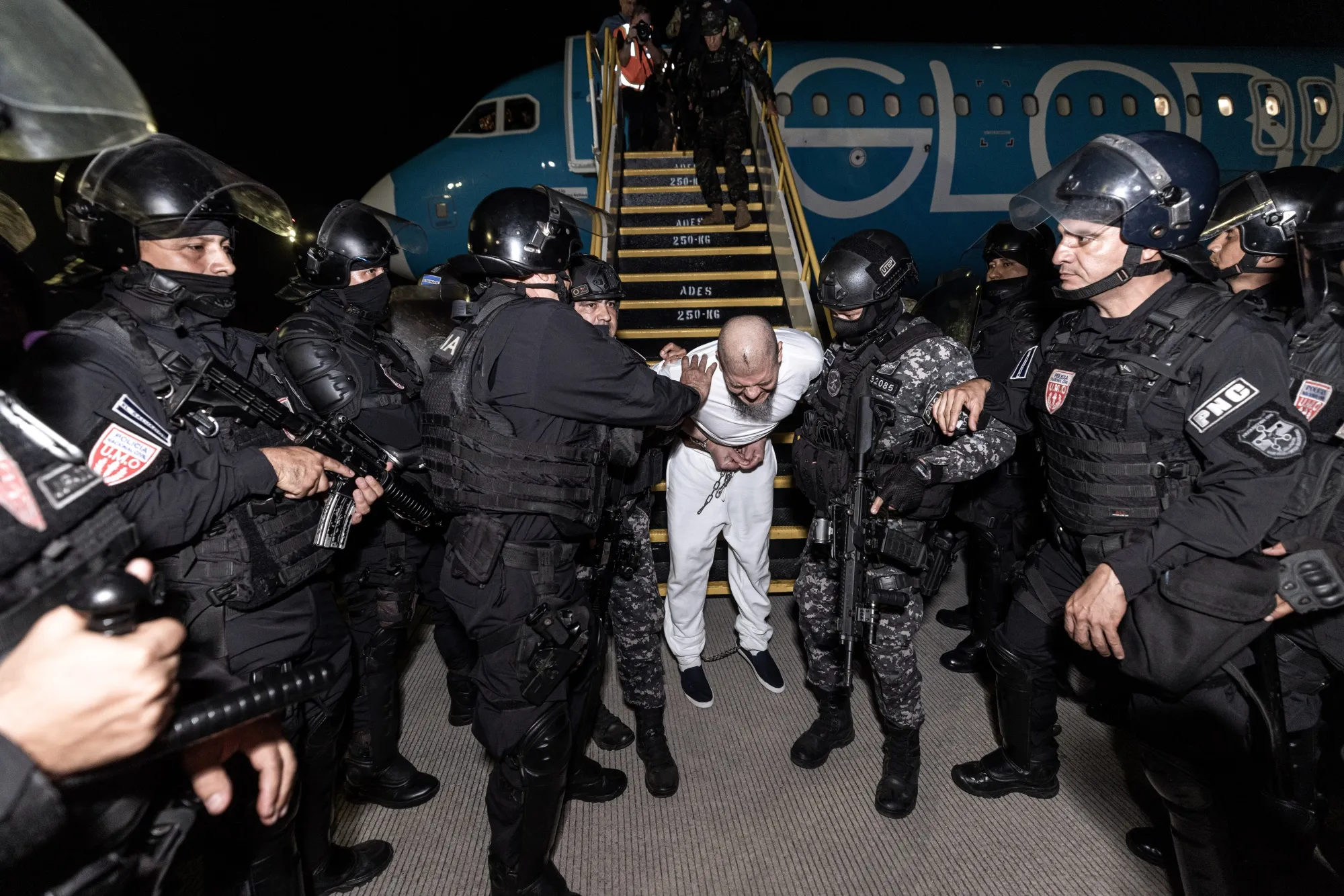 Suspected gang members arrive in El Salvador after deportation by the US.