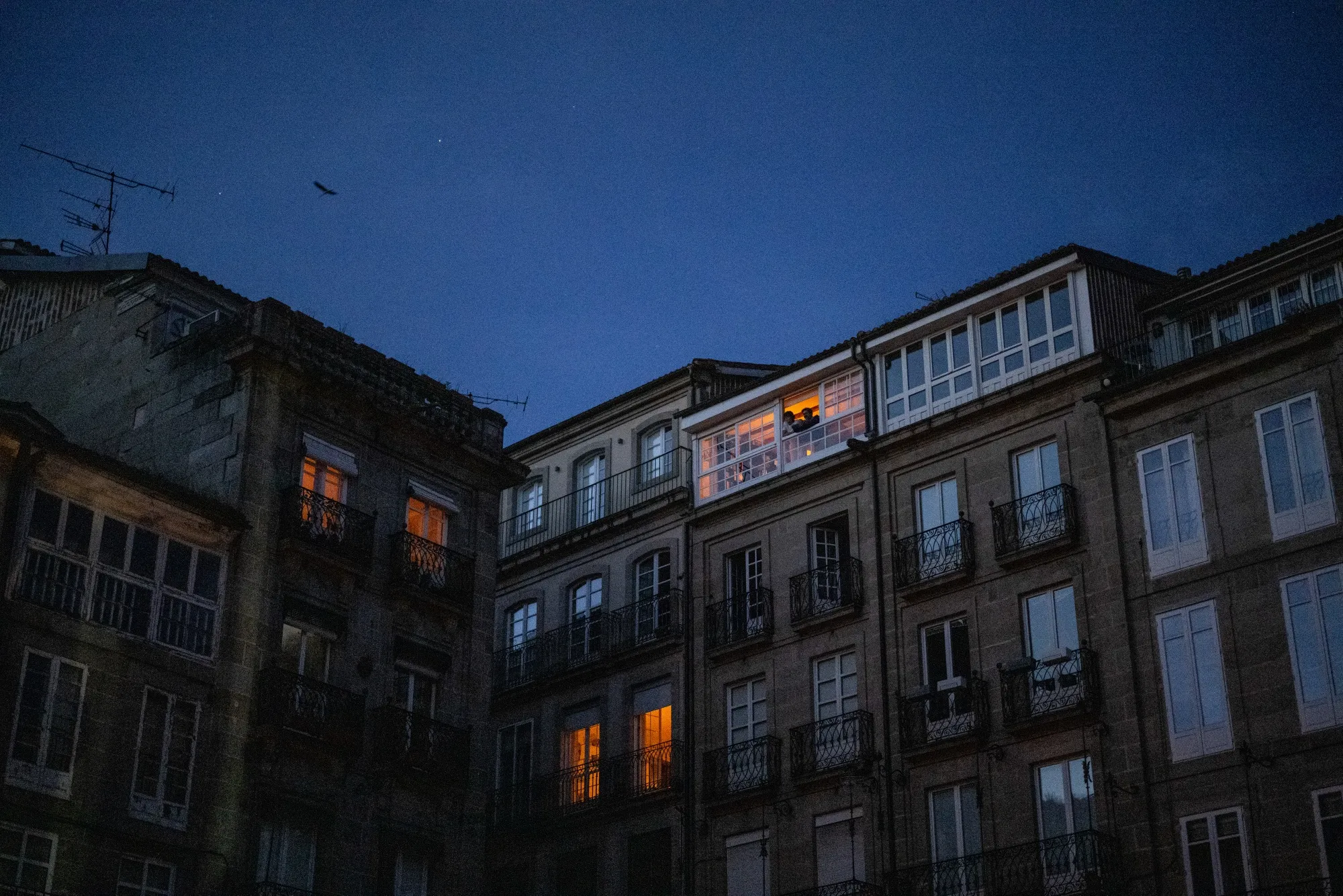 Candle lit windows in residential buildings during a power outage in Ourense, Spain, on Monday, April 28.&nbsp;