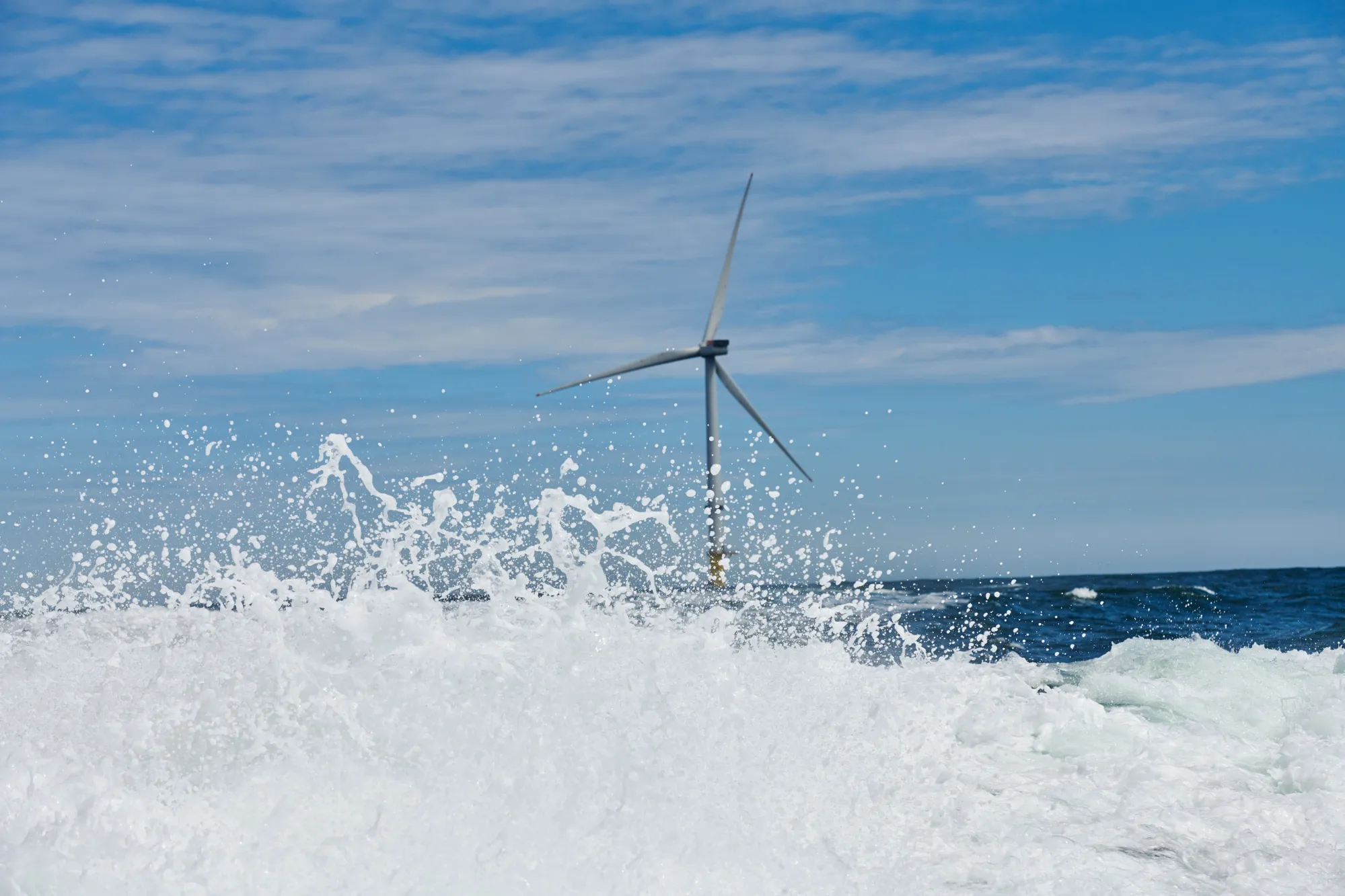 Wind turbines stand at an offshore wind farm