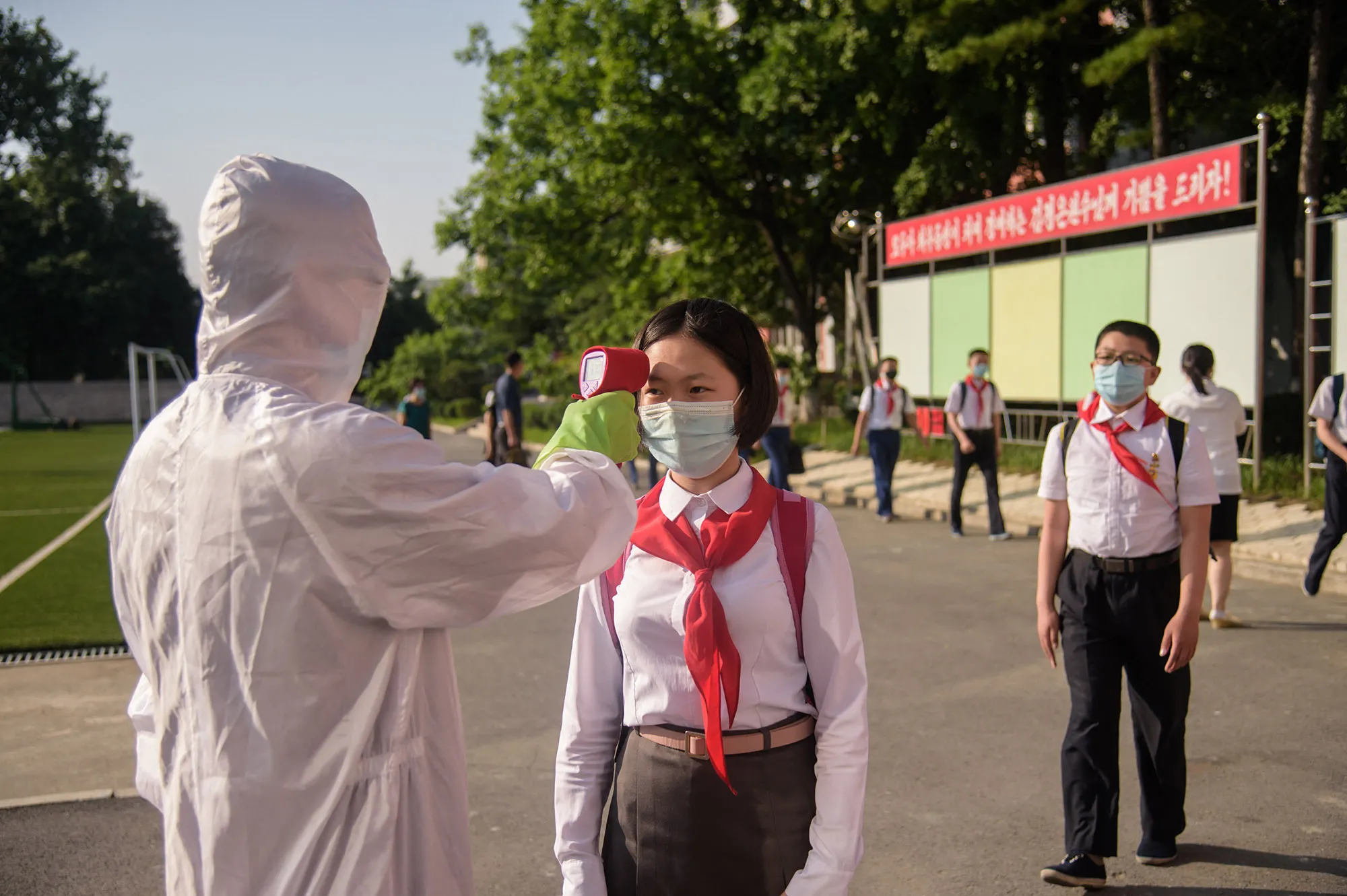 A pupil has her temperature taken&nbsp;before entering the Pyongyang Secondary School No. 1, in Pyongyang.