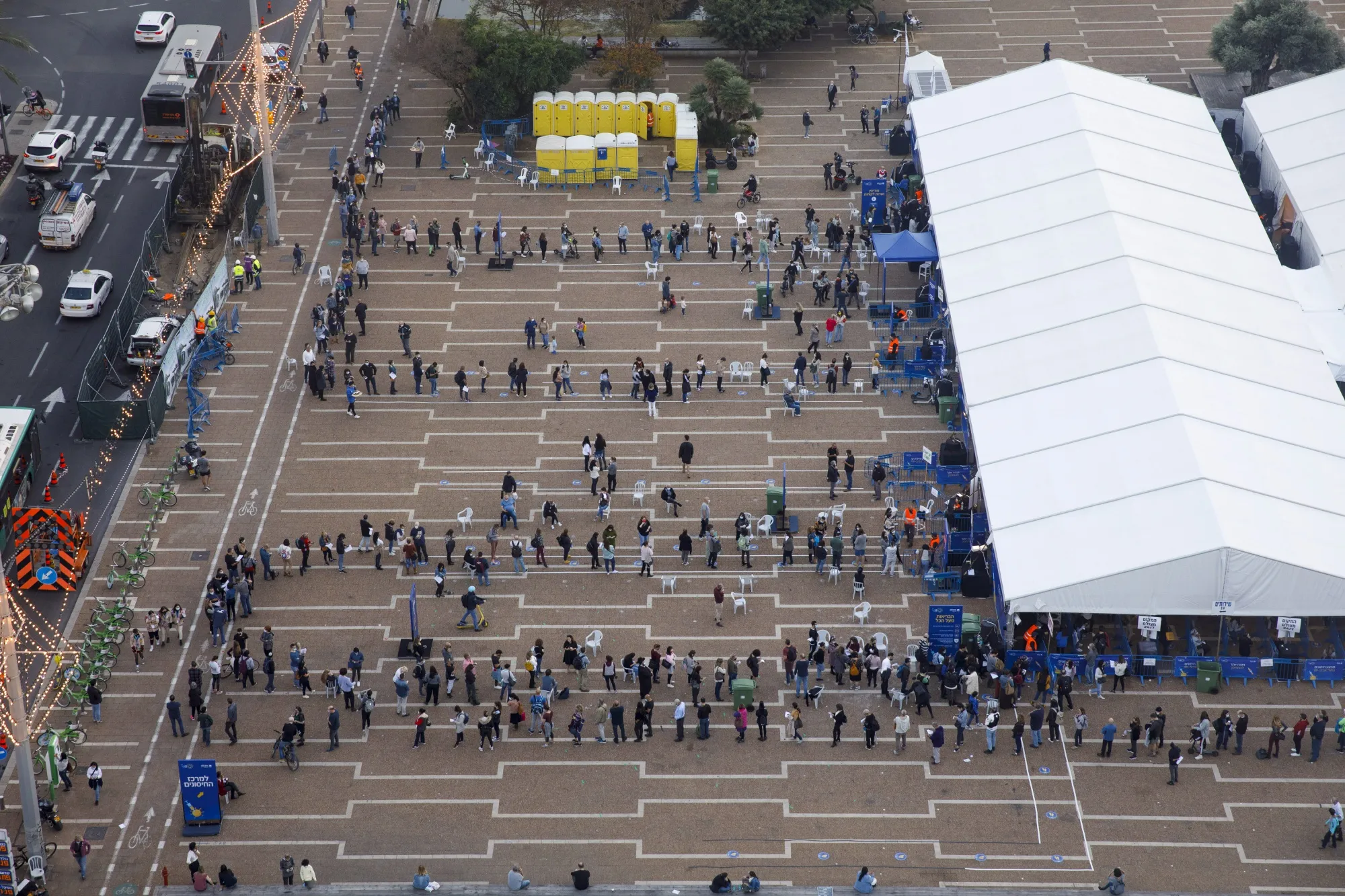 People queue outside a Covid-19 mass vaccination center at Rabin Square&nbsp;in Tel Aviv.