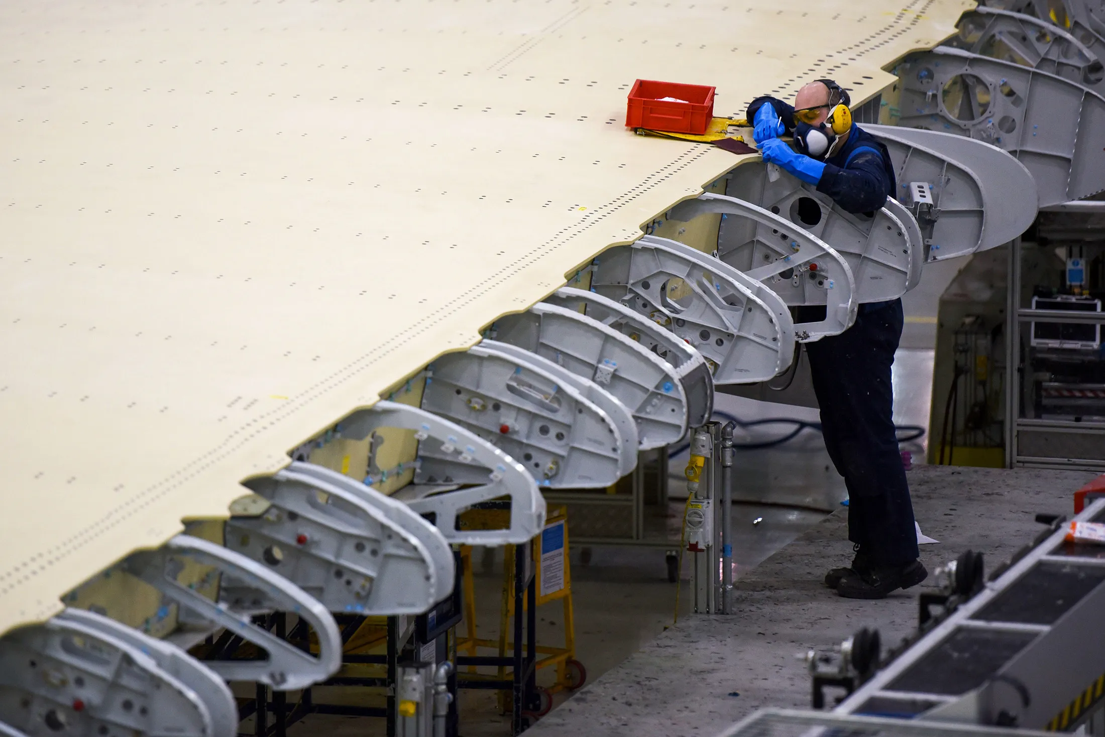 An employee works on a section of a wing on the Airbus A350 wing production line at the Airbus SE assembly factory in Broughton, U.K.
