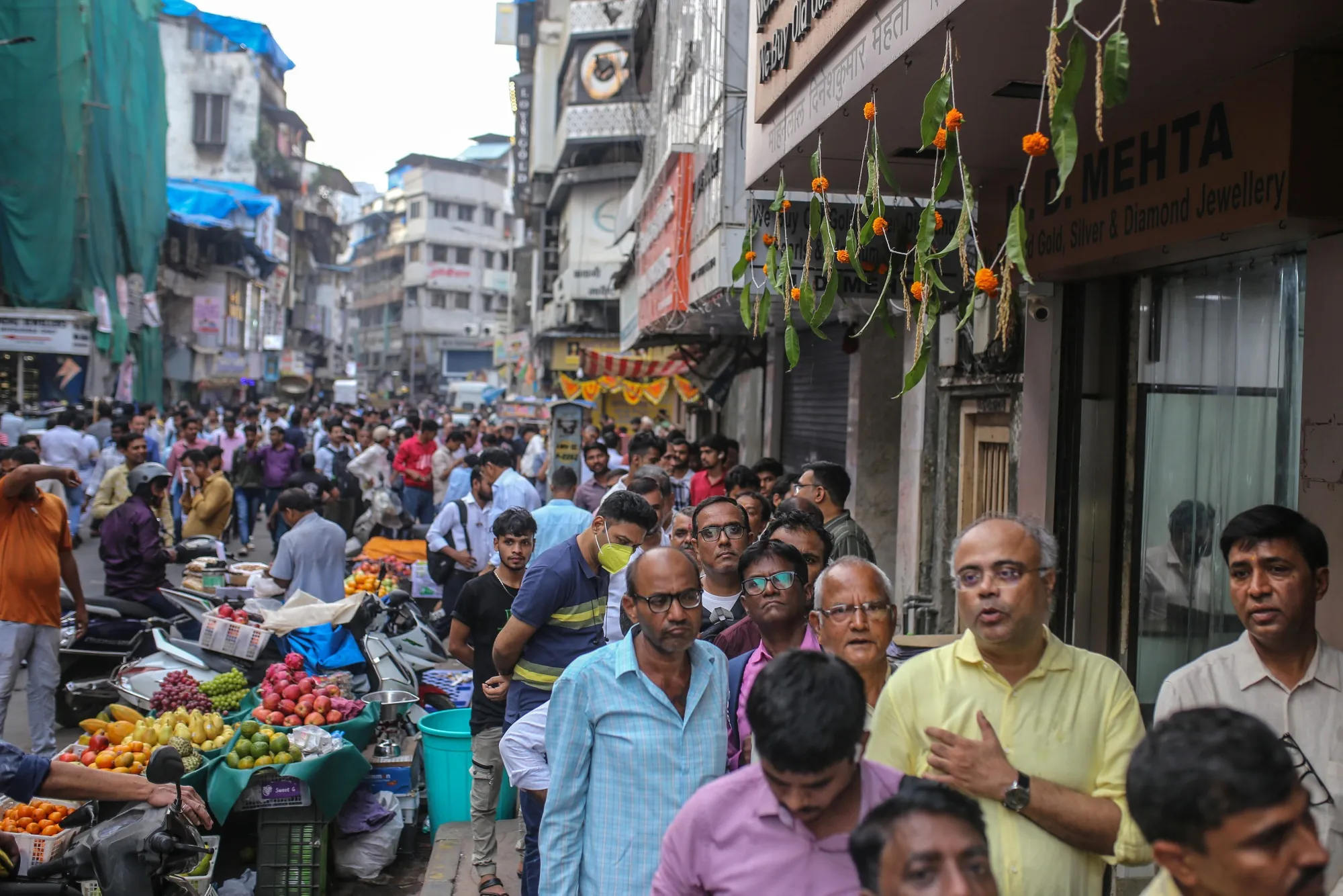 Customers queue outside a jewelry store at Zaveri Bazaar during the festival of Dhanteras in Mumbai.