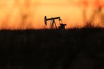An oil pumpjack works at dawn in the Permian Basin oil field in Andrews, Texas. (Photo by Spencer Platt/Getty Images)