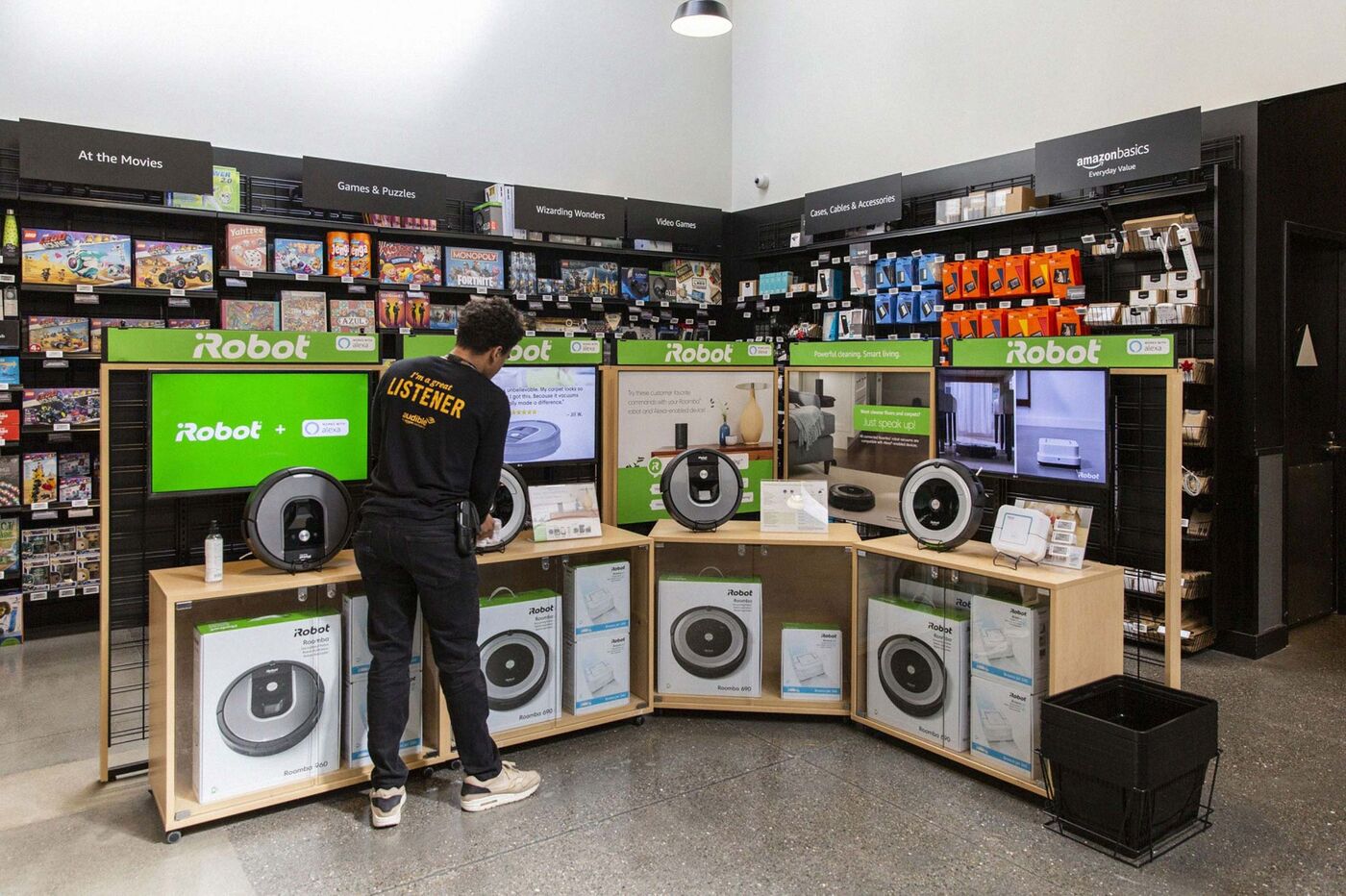 An employee cleans an iRobot Corp. Roomba display inside an Amazon.com Inc. 4-star store in Berkeley, Calif. on March 29, 2019.