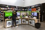 An employee cleans an iRobot Corp. Roomba display inside an Amazon.com Inc. 4-star store in Berkeley, Calif. on&nbsp;March 29, 2019.