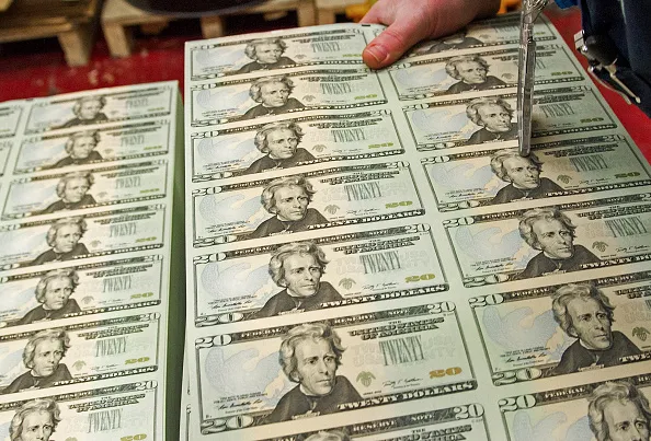 A stack of uncut sheets of $20 bills.