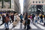 Shoppers walk along Fifth Avenue on Black Friday in New York.