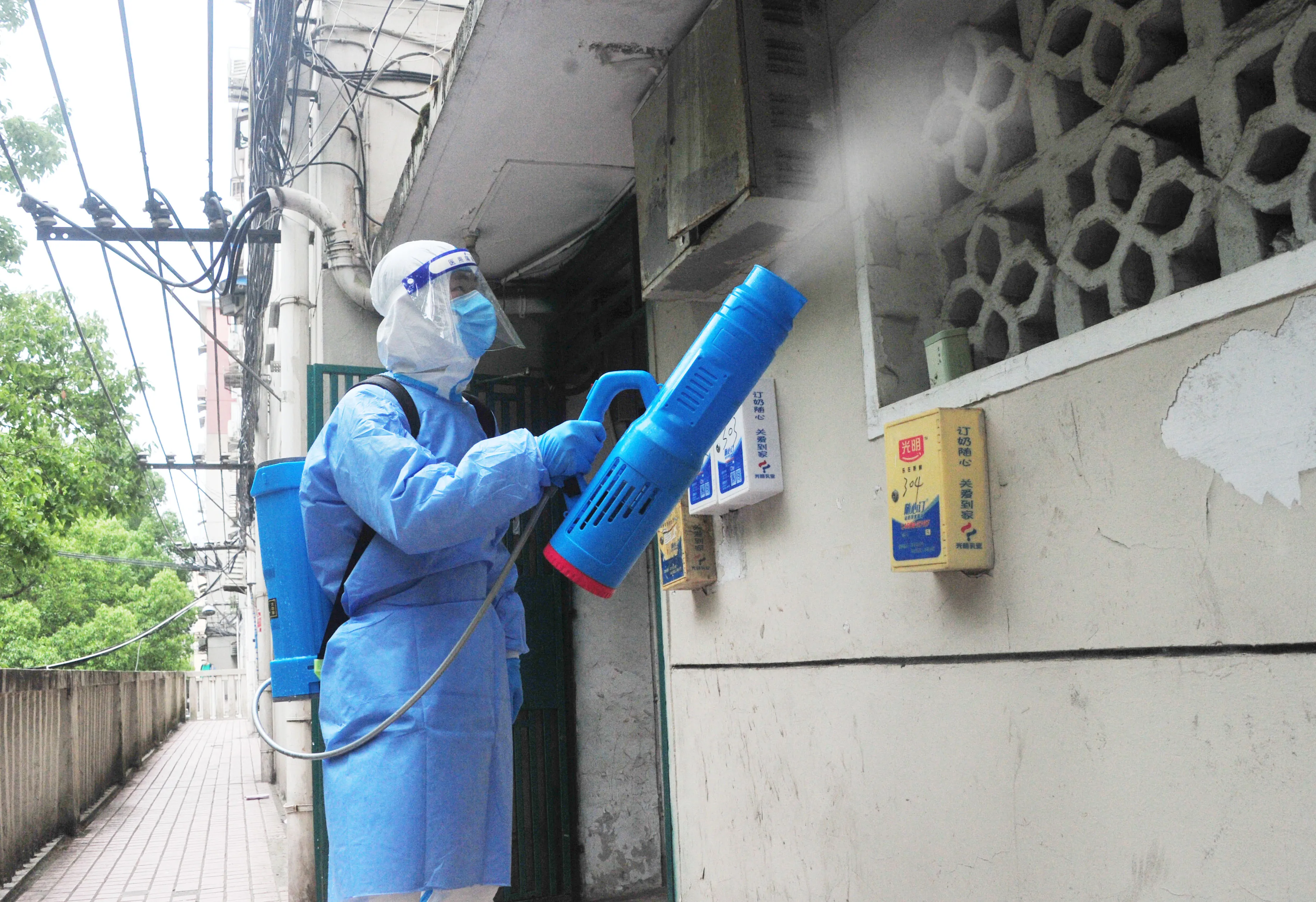 A health worker sprays disinfectant at a gated community during the phased lockdown in Shanghai on May 11.