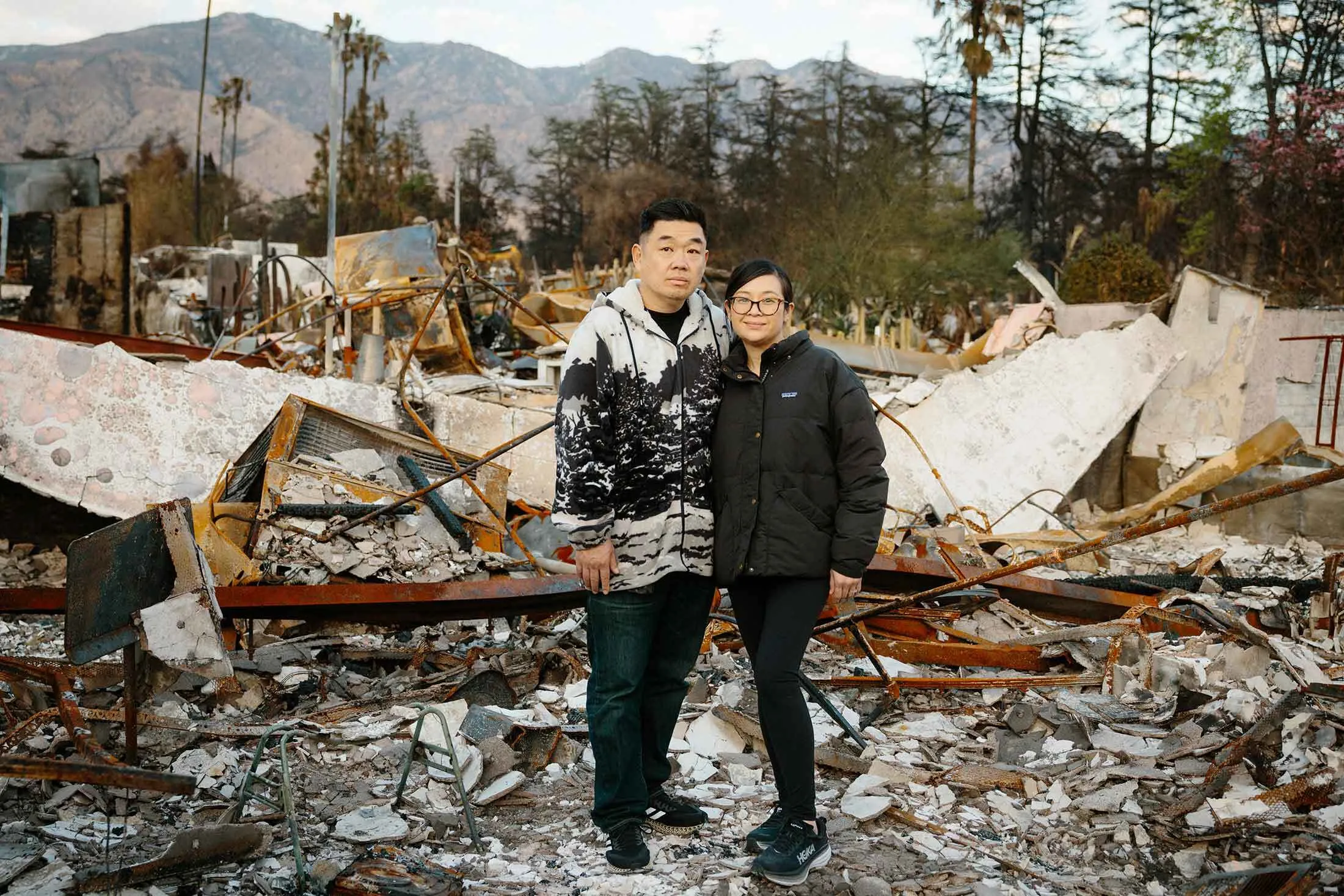 Chien (left) and Kim Yu in front of the ruins of their home in Altadena, California.
