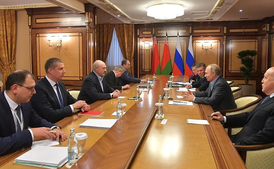 Alexander Lukashenko, third left, speaks with Vladimir Putin in Sochi, Russia, on Feb. 7.