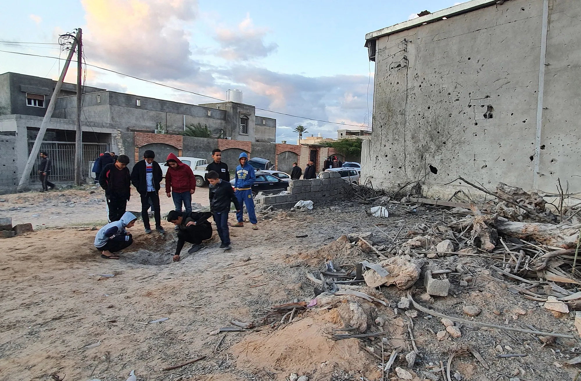 Libyans inspect damage from a reported airstrike in the capital Tripoli's suburb of Tajoura, on Dec. 29.