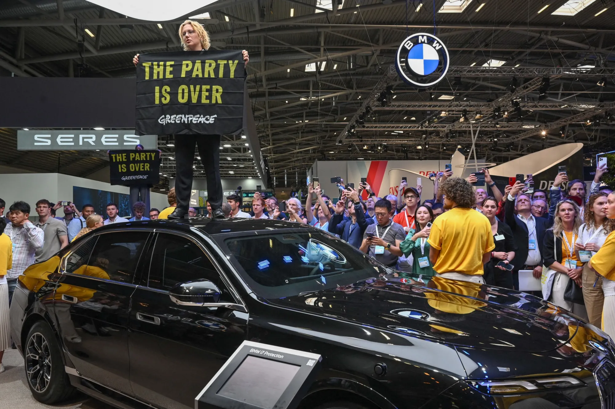 Environmental activists of Greenpeace demonstrate at the German car maker BMW booth at the International Motor Show.