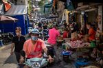 People wear protective masks while shopping at a wet market in the Old Quarter in Hanoi, Aug. 15.