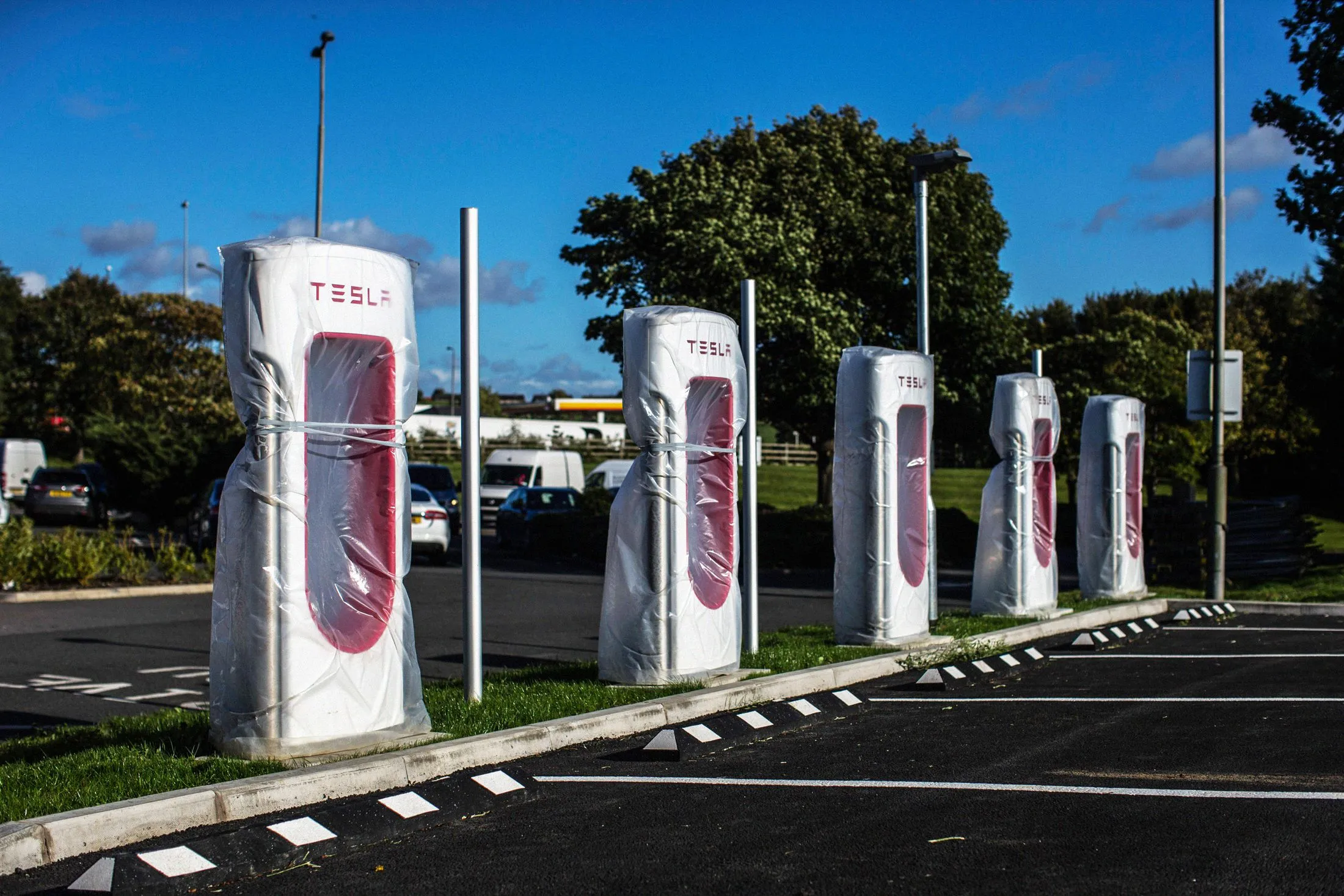 Tesla Inc. charging stations wait to be unwrapped at the Hartshead Moor service station off the M62 motorway near Bradford, U.K., on Oct. 5, 2017.