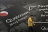 An attendee walks past an advertisement for Qualcomm Inc.'s Snapdragon processors at the MWC Shanghai exhibition in Shanghai, China, on Thursday, June 27, 2019. The Shanghai event is modeled after a bigger annual industry show in Barcelona.