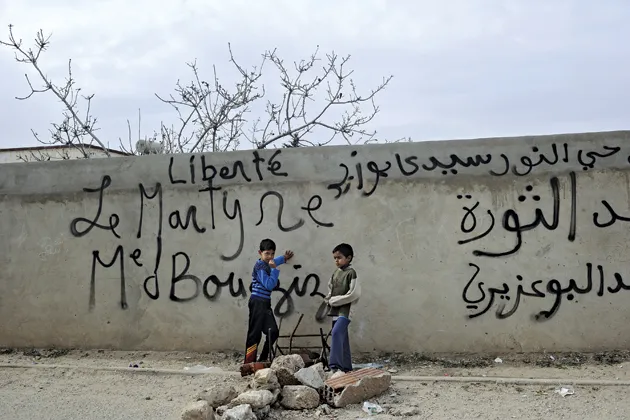 Children play on the street in Sidi Bouzid where Mohamed Bouazizi lived